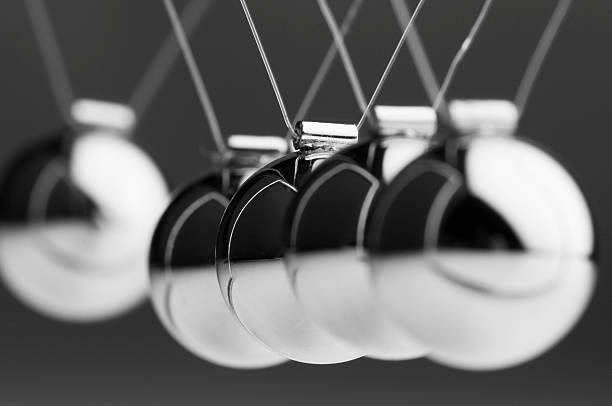 istock Silver ball in Newton’s cradle swings back toward others 183876712
