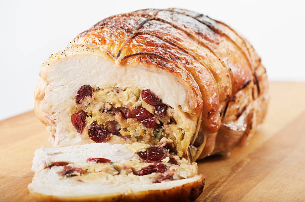 Stuffed Turkey Breast "Roasted turkey breast that's been stuffed with traditional stuffing and dried cherries, then rolled, tied and roasted." turkey breast stock pictures, royalty-free photos & images