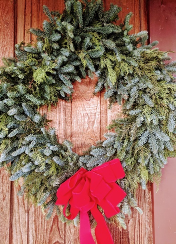 A Christmas wreath on a wooden wall