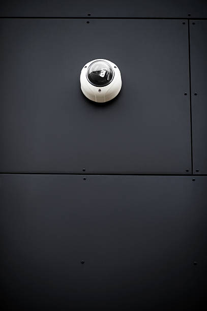 Surveillance concept - Security video camera on wall of building