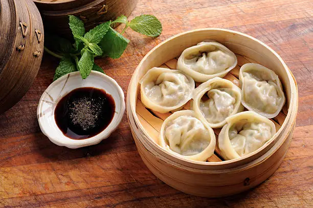 Dumplings in Bamboo Steamer with Soy Sauce.
