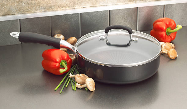 Non-stick saute pan on kitchen counter High-end saute pan with glass lid polytetrafluoroethylene photos stock pictures, royalty-free photos & images