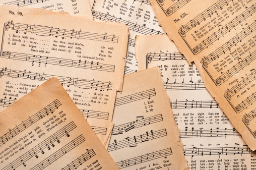 Old sheet music on parchment paper from an antique hymnal.  The printing is copyrighted 1890 and is in the public domain.