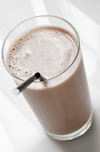 Tall glass of chocolate milk; could work as a chocolate energy drink, diet drink, protein drink, meal replacement, etc.