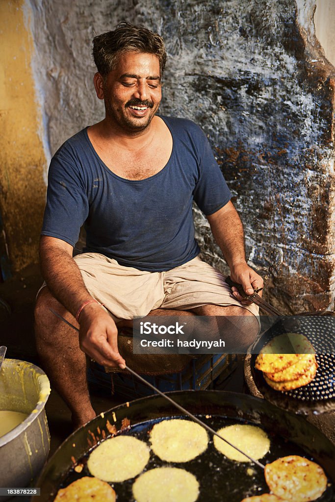 Indian street vendor "A street vendor preparing food, Rajasthan, India." Adult Stock Photo