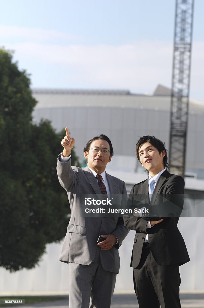 Businessman at construction site Japanese investors on an on-location check at a construction site in Tokyo, Japan 20-29 Years Stock Photo