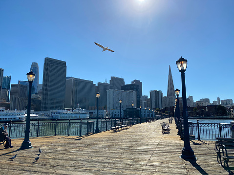 San Francisco in 2023: Ferris Wheel in Fisherman's Wharf under construction, Oakland-Bay-Bridge, Pier 7, Bow and Arrow Sculpture in Rincon Park, Dutch Windmill in Golden Gate Park and a steakhouse by night at Embarcadero.