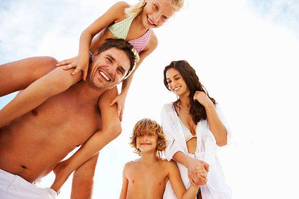istock Cheerful couple with kids on a sunny day 183879356