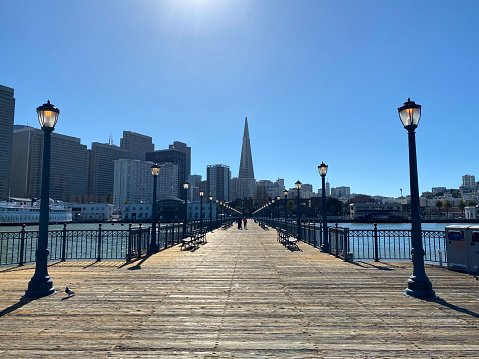 San Francisco in 2023: Ferris Wheel in Fisherman's Wharf under construction, Oakland-Bay-Bridge, Pier 7, Bow and Arrow Sculpture in Rincon Park, Dutch Windmill in Golden Gate Park and a steakhouse by night at Embarcadero.