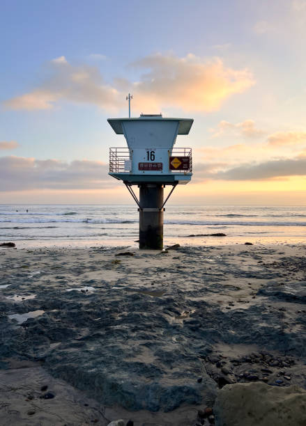 Bask in the coastal charm of San Elijo beach in San Diego, where a vibrant lifeguard tower stands tall against the blue sky