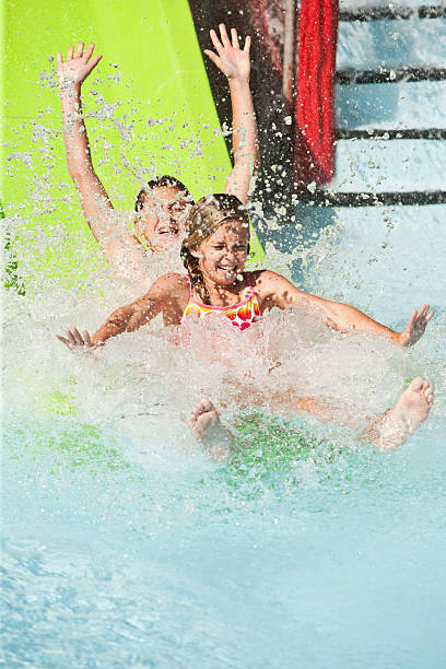 Boy, 13 years, and sister, 11 years, landing at bottom of water slide