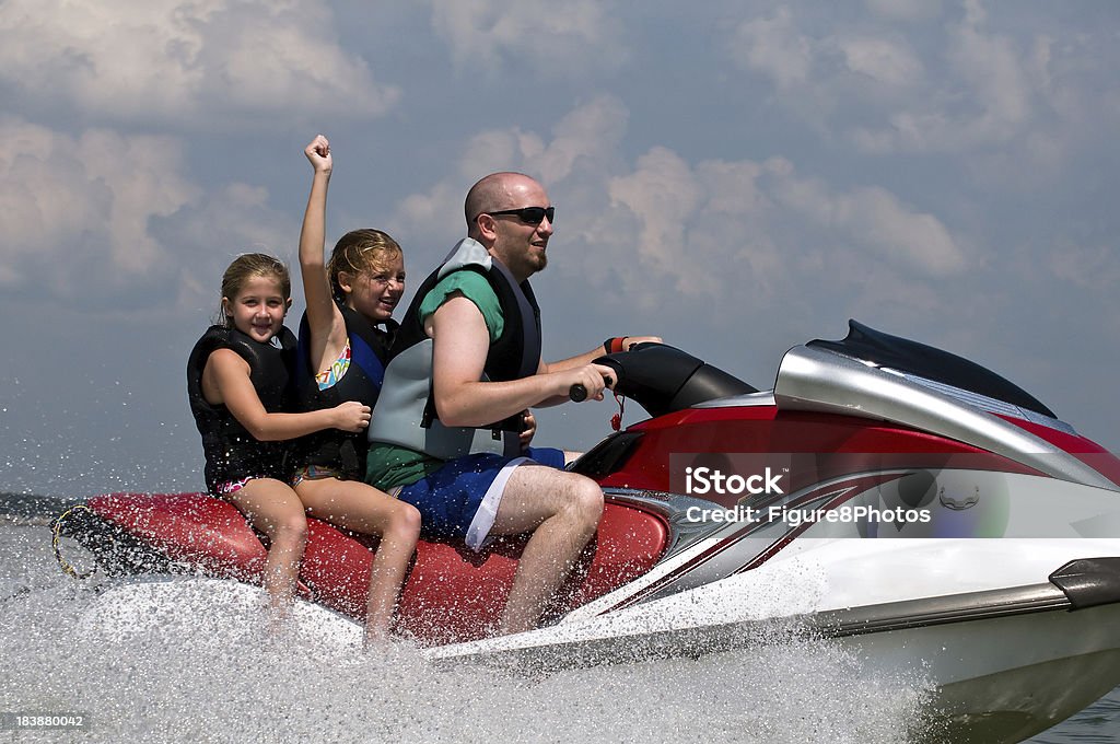 Lake fun on personal watercraft Three people riding on a personal water craft. Activity Stock Photo