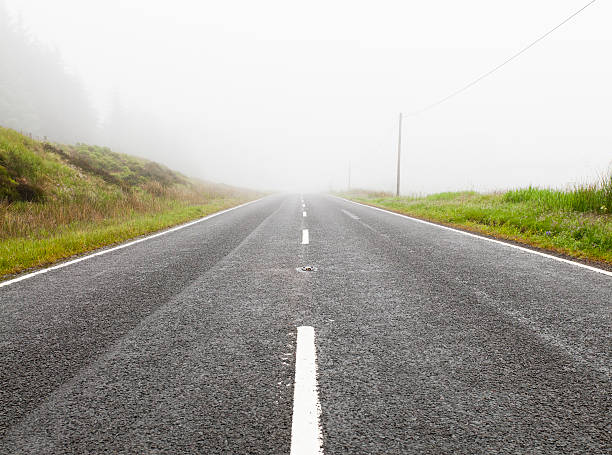istock Road Disappearing Into Fog 183880378