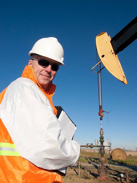 istock Oil Worker in Safety Gear at Well Pumpjack 183880956