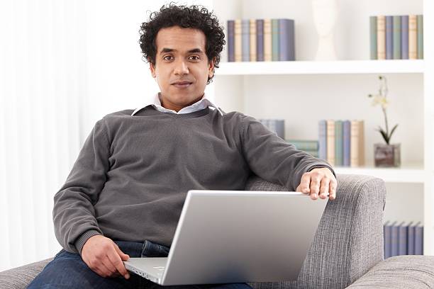 Young man with laptop stock photo