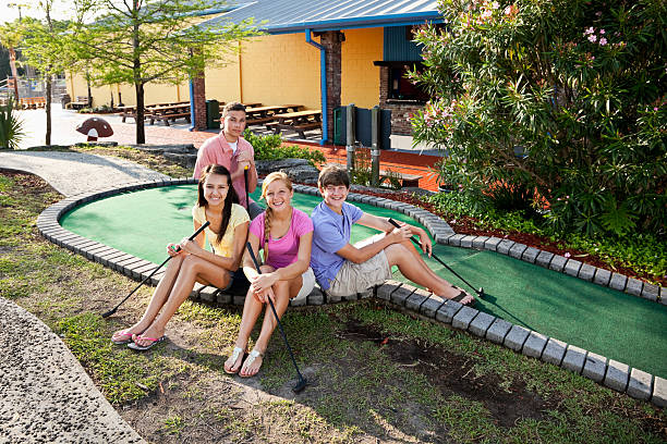 istock Teenage couples at miniature golf course 183881665