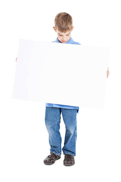 istock Young Boy Looking Down at Blank White Sign 183882215