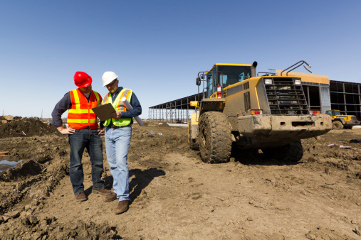 A royalty free image from the construction industry depicting an architect and engineer at a construction site.