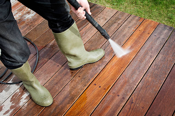 istock Man Cleaning Patio Decking With a Pressure Hose 183883378