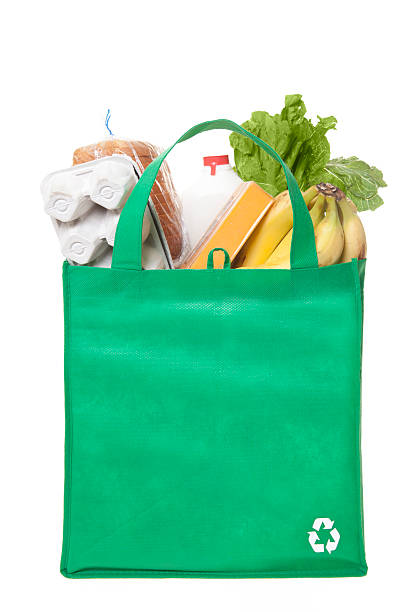 reusable grocery bag A reusable grocery bag with recycle symbol reusable bag stock pictures, royalty-free photos & images