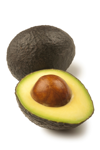 Whole and Sliced Hass Avocado isolated on a white background. Clipping path included.