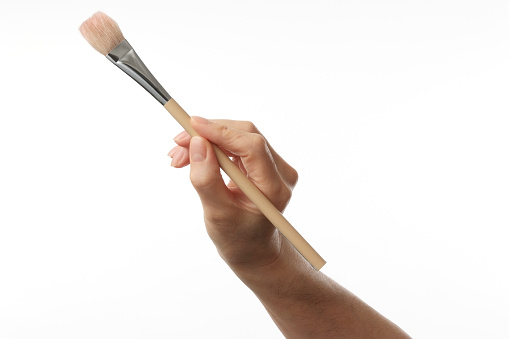 Working painter hand with paintbrush, isolated on a white background.
