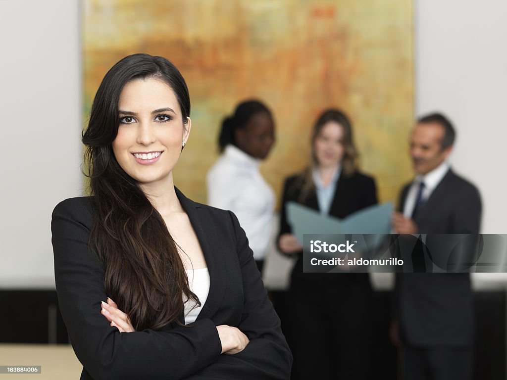 Confident business woman with her team Confident business woman with her team working Adult Stock Photo