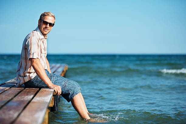 istock Man relaxing on wooden pier 183884046