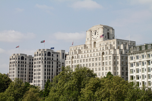 This is a view of the buildings opposite London's South Bank (the centre for arts that includes the Hayward Gallery, the National Theatre and the Royal Festival Hall). The view includes the prominent buildings on the north bank of the Thames as they are seen from the southern end of Waterloo Bridge. On the far left is the Adelphi Building at 1-11 John Adam Street. It was completed in a notable Art Deco style by Stanley Hamp of Colcutt and Hamp in 1938. In the middle is Shell Mex House, now correctly known as simply 80 Strand. The current building was completed in 1930–31 on the site of the Cecil Hotel. It is immediately recognizable from the River Thames by the clock tower positioned on the south side of the building. In 1975, it became the head office of Shell UK Ltd. Finally, in the 1990s, 80 Strand became the HQ of Pearson plc. Just peeping in at the at right hand edge is the Savoy Hotel.