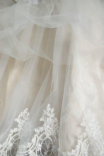 Abstract of lace and chiffon detail on an ivory wedding dress