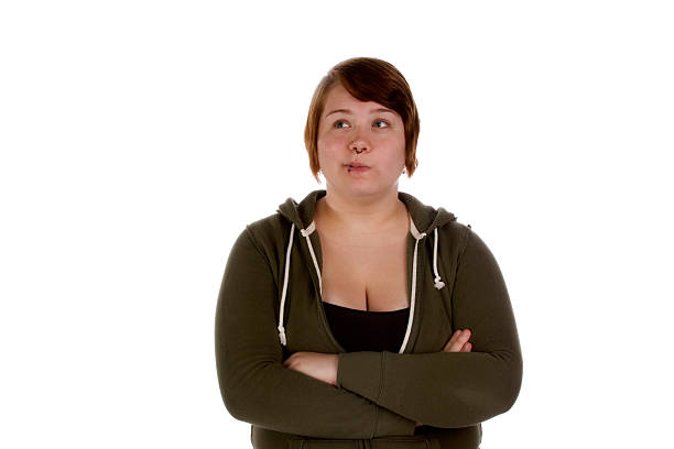 Pierced teenager female looks away while exhibiting doubtful body language