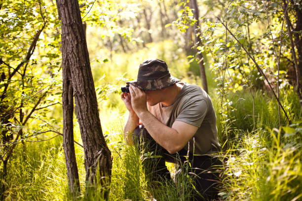 istock Young man on safari holding binoculars 183887392
