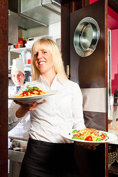 istock waiter coming out of the kitchen 183888066