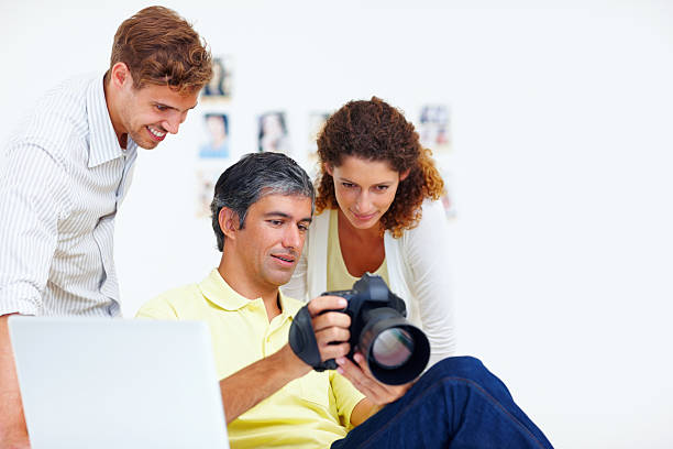 istock Photographers viewing photos in a camera 183888424