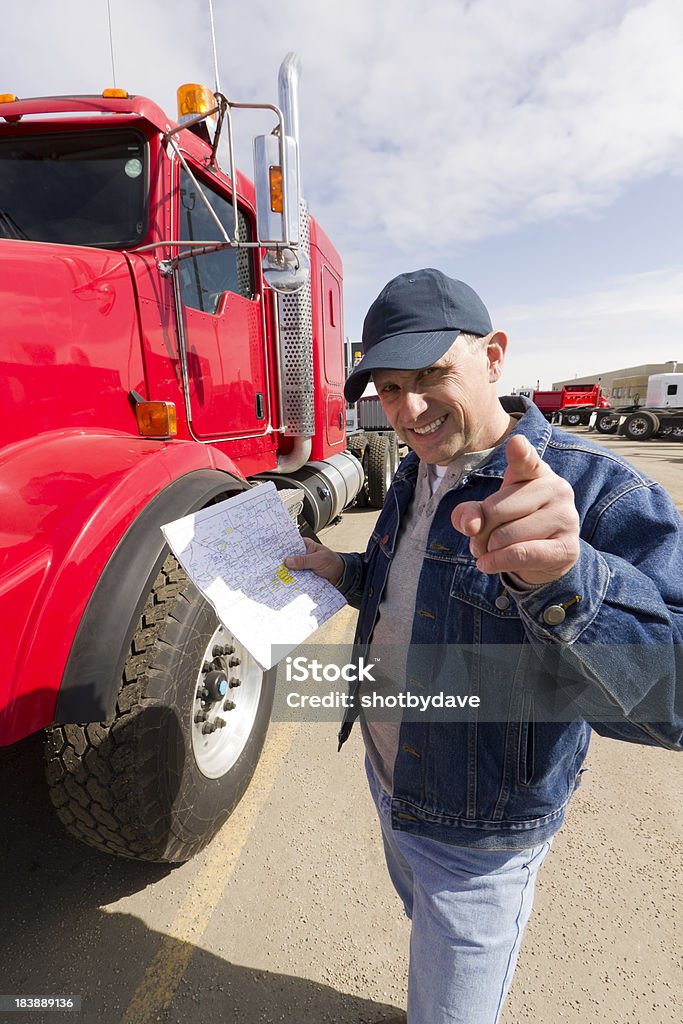 Pointing Courier A friendly truck driver points towards the camera as he hold a map. Document Stock Photo