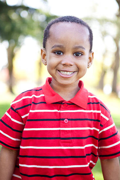 istock african american boy looking at camera in park 183889464