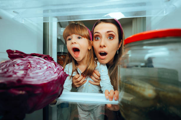istock Mother and Daughter Looking Surprised in the Fridge 1838896978
