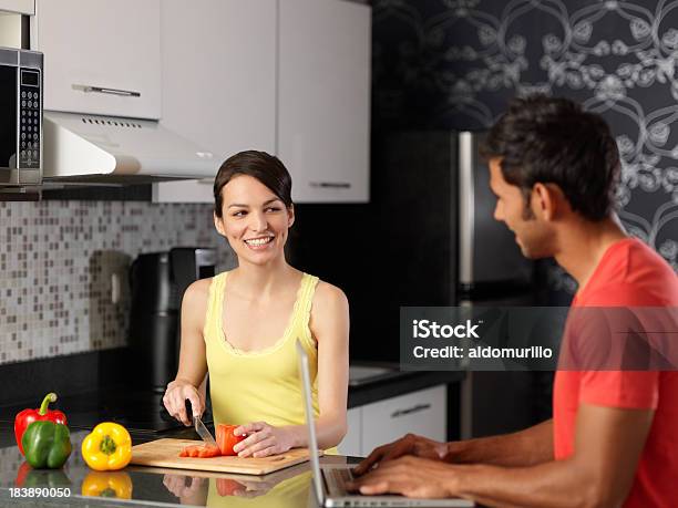 Latin Woman And Man Hanging Out In The Kitchen Stock Photo - Download Image Now - 20-29 Years, Adult, Beautiful People