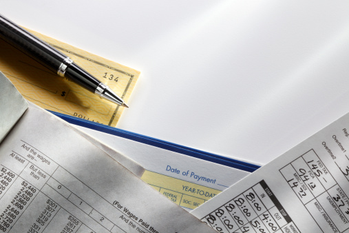 A payroll tax table and an employee's time card.Please see some similar pictures from my portfolio: