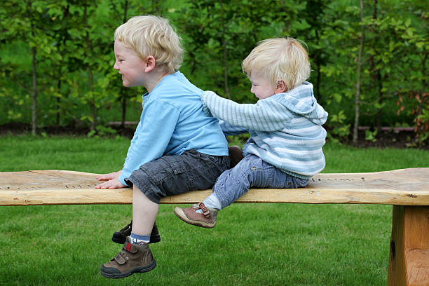 istock brothers playing outdoors 183890322