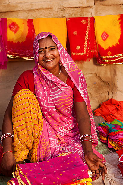 istock Woman selling colorful fabrics 183891115