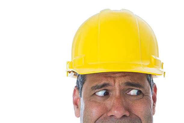 istock Part of man wearing hardhat making face looking towards left 183891221