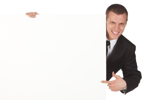 Happy businessman pointing at blank signhttp://www.twodozendesign.info/i/1.png