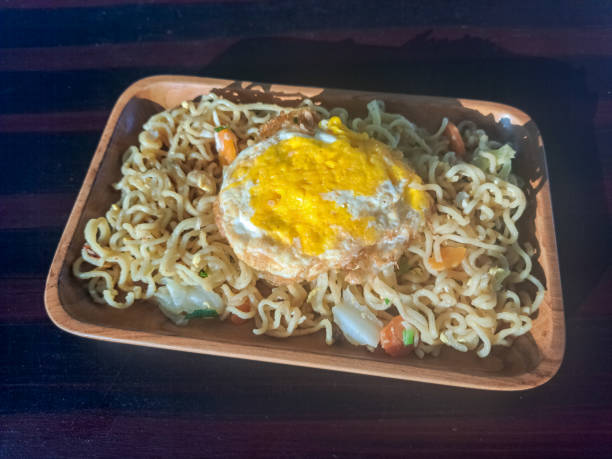 istock Instant Fried Noodles. Served With Fried Omelette Eggs, Cabbage And Chopped Chives Green Onions. Mi Goreng Instant Dengan Telur. Food Menu 1838915468