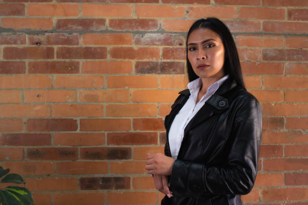 istock Young woman posing in front of a brick wall 1838918678