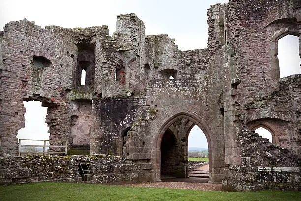 "A church can be seen in the distant landscape through the ruins of the magnificent 15th century Raglan Castle, in Wales. Once an aristocratic estate, the Raglan Castle was a casualty of the English Civil War in the 17th century, and is now a popular tourist attraction."