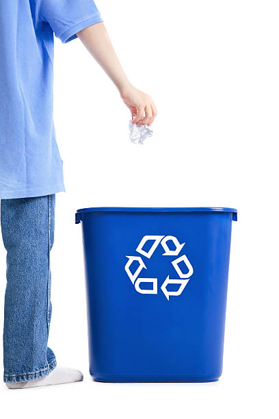 istock Boy Dropping Wad of Paper Into Recycle Bin 183892684