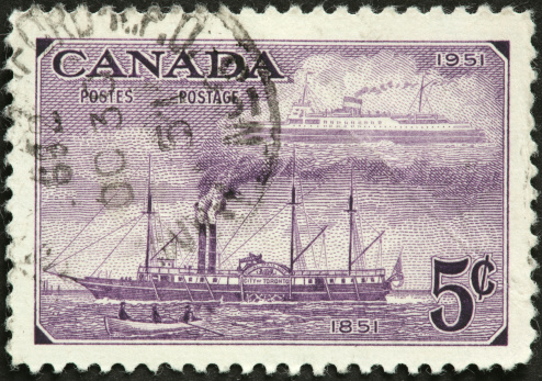 vintage Canadian sidewheel steamship on an old postage stamp