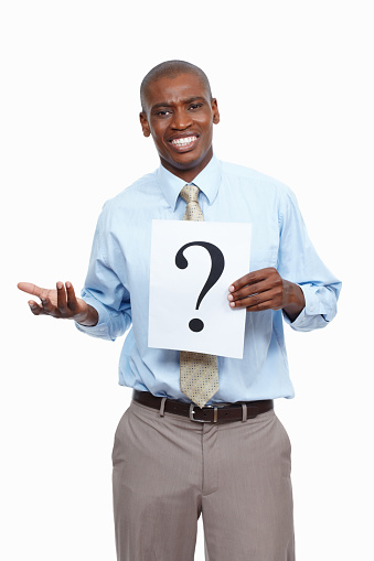 Portrait of business man standing on white background holding a question mark sign
