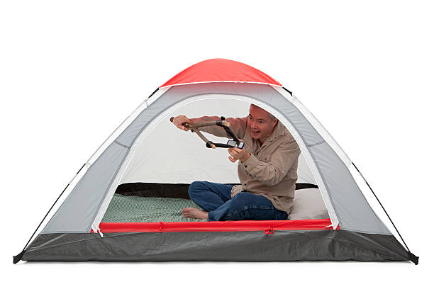 Father and son beside their tent on a sunny day
